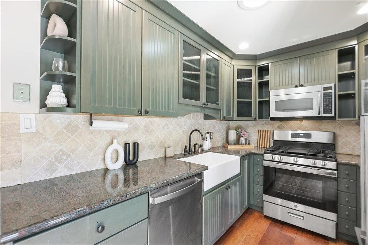 Sage green kitchen cabinetry detail, garden cottage in Saratoga